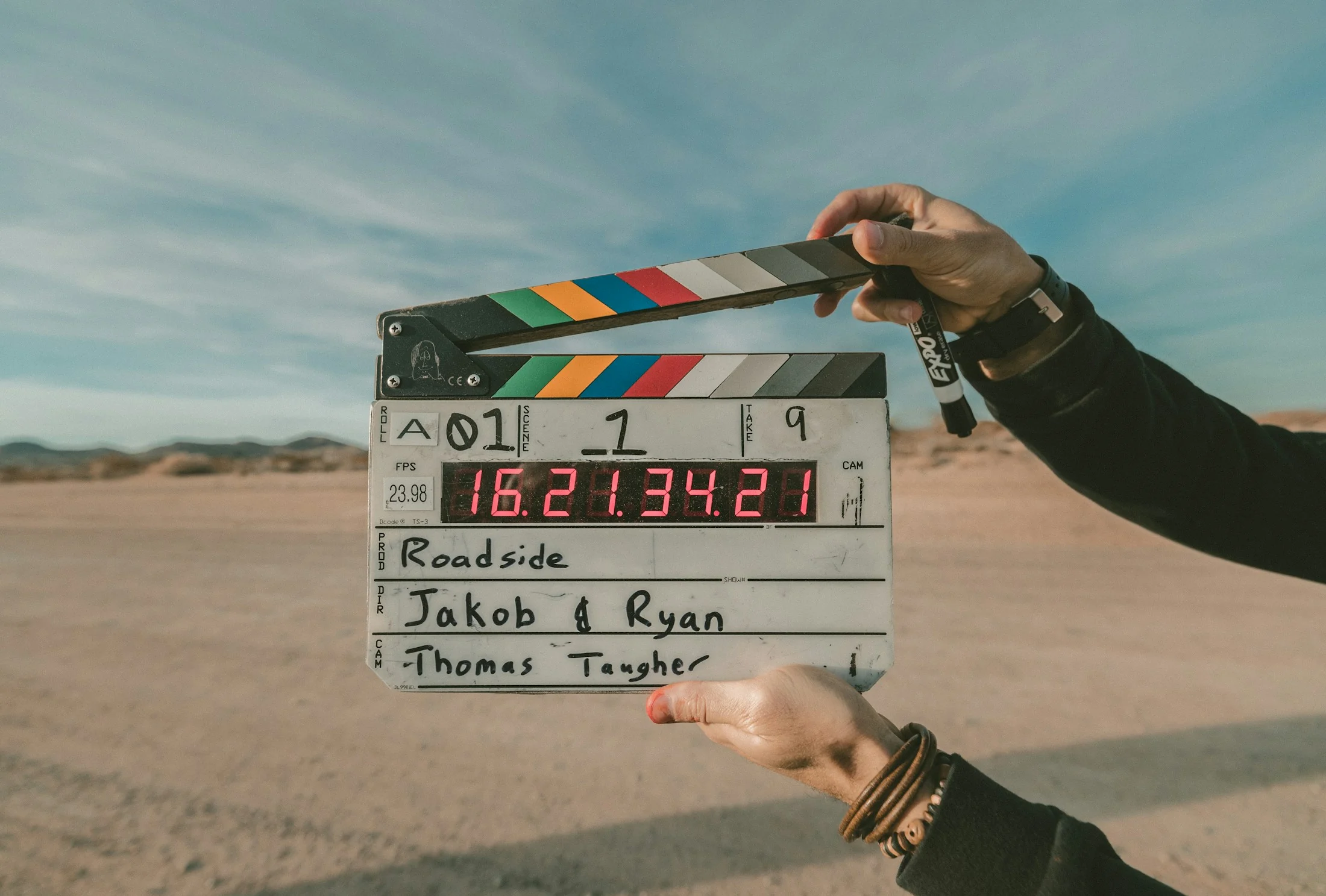 Film clapperboard held on location for a video production.